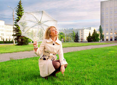 beautiful young lady with umbrella in city without peopleの写真素材
