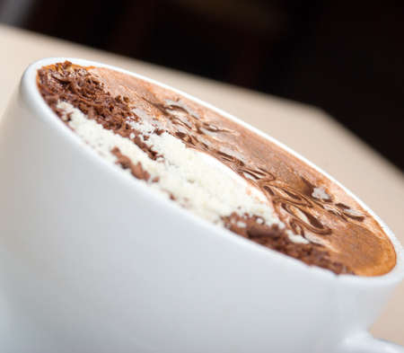 cappuccino cup.coffee . Shallow depth-of-field. with washed away by back background
