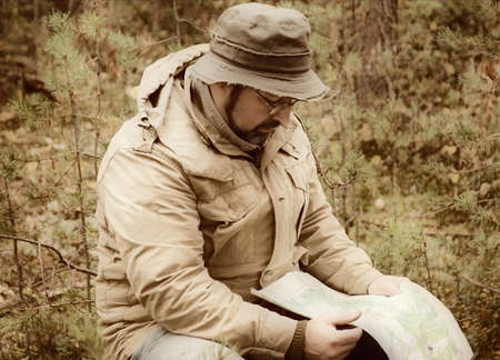Hiker with map in forest .boondocks -taigaの写真素材