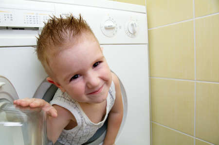  caucasian  small boy from washer の写真素材
