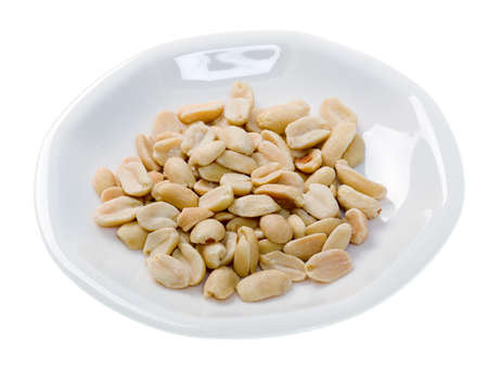 Roasted Peanuts in white plate isolated 