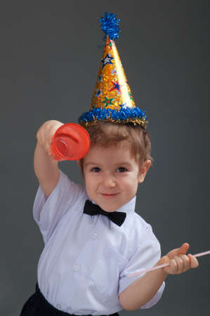 Boy drinking juice isolated on white の写真素材