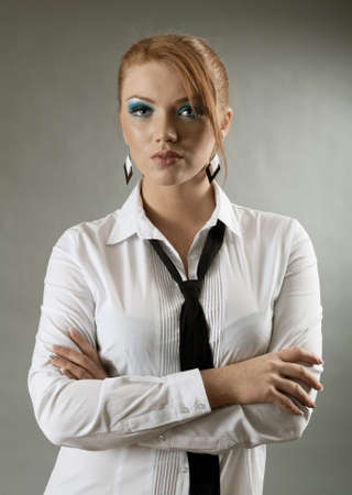 redheaded girl  in formal dress like a secretary with white shirt and tie の写真素材