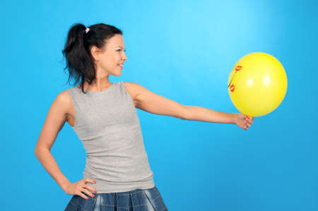 merry girl with air ball  on blue backgroundの写真素材