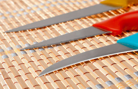 Set of kitchen knifes on bamboo napkinの写真素材