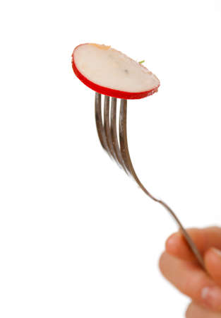 Close-up .fork with radish .Studio, white background. の写真素材