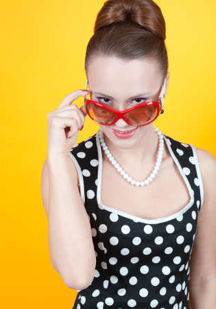 Girl in american 60s style in  polka dot dress の写真素材