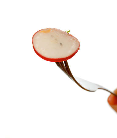 Close-up .fork with radish .Studio, white background. の写真素材