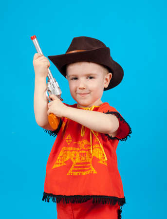 little boy wearing a cowboy hat a over blue backgroundの写真素材