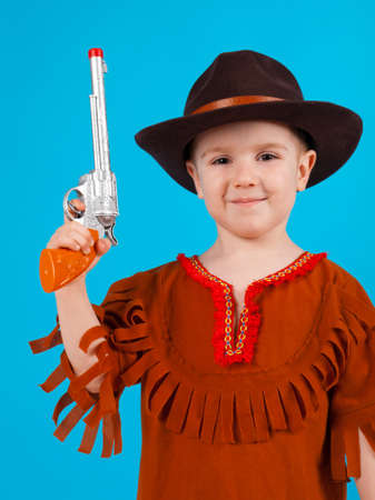 little boy wearing a cowboy hat a over blue backgroundの写真素材