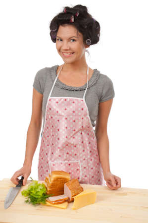 Beautiful cooking woman in apron with sandwich.Studio, white background. の写真素材