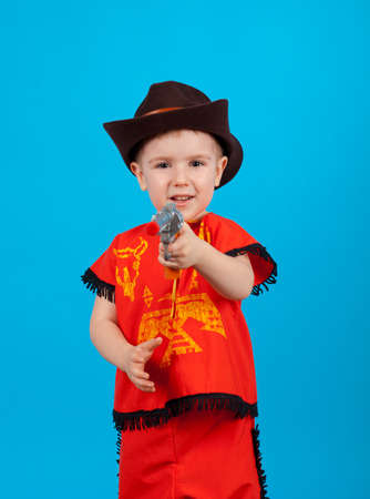 little boy wearing a cowboy hat a over blue backgroundの写真素材