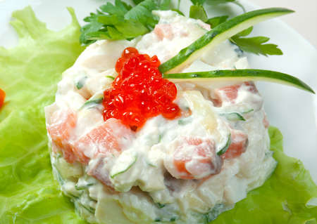Healthy vegetarian Salad with salmon and roe on the white plate over whiteの写真素材