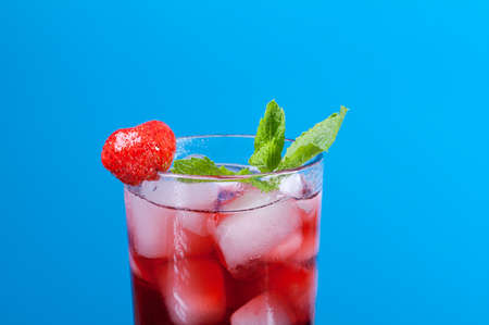 Mojito strawberries  cocktail. closeup  on  blue background.の写真素材