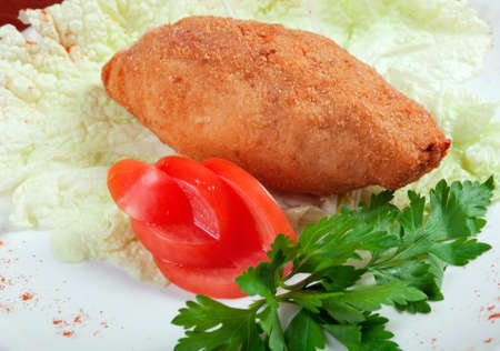 Italian cuisine.Chicken cutlets with parsley on white plate