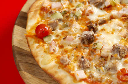 Pizza east with tomato. italian kitchen. Studioの写真素材