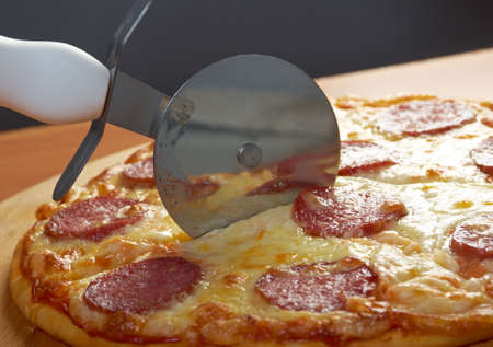 homemade pizza  Pepperoni.Closeup  a knife cut the pizza の写真素材