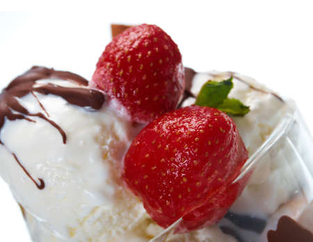ice cream  with chocolate sauce and strawberries,cinnamon. closeup.isolated on white background.