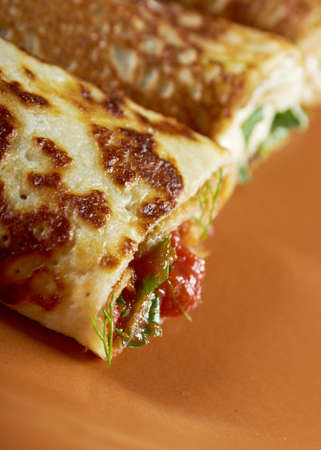 rolled pancakes stuffed ham and cheese. Shallow depth-of-field.の写真素材