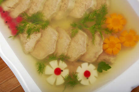 Aspic from meat decorated with egg, carrot,