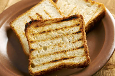 pile  toasted bread slices for breakfast.Close up of toasted white bread in slices