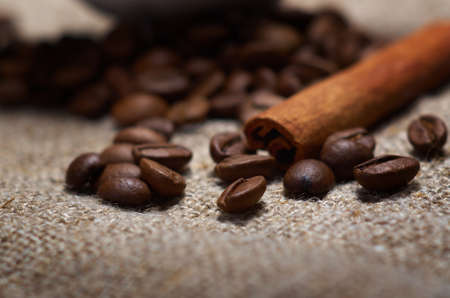 Coffee cup with cinnamon and coffee beans backgroundの写真素材