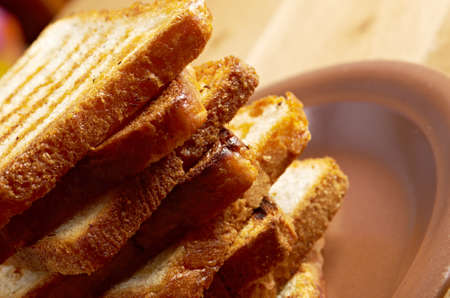 pile  toasted bread slices for breakfast.Close up of toasted white bread in slices