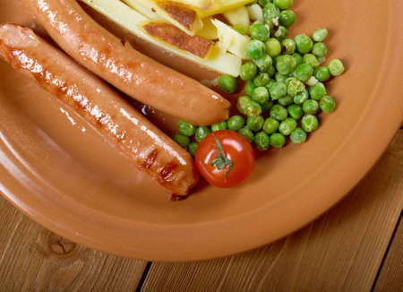 Sausages with french fries and vegetablesの写真素材