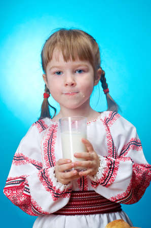 Russian little girl drinking glass of milkの写真素材
