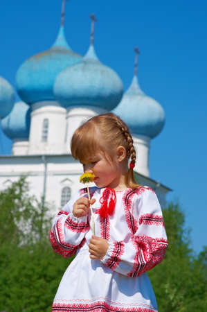 Russian little girl  on a orthodox church background.の写真素材