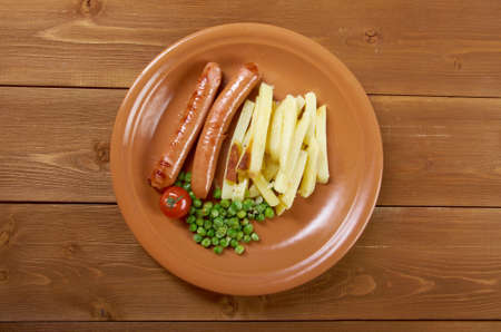 Sausages with french fries and vegetablesの写真素材