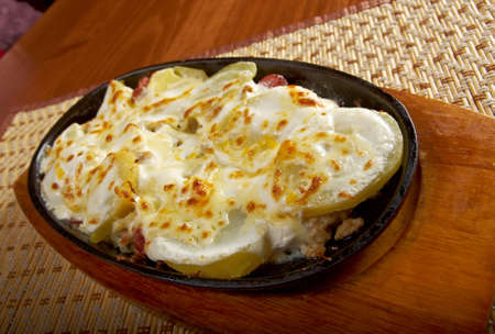 Fried eggs with potato and spring onionsの写真素材