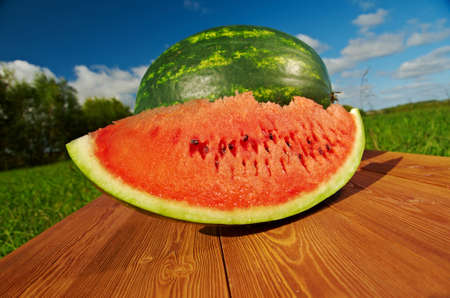 Watermelon slices on a wooden table.の写真素材