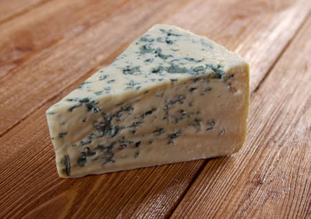 Blue cheese on wooden background.farm-style
