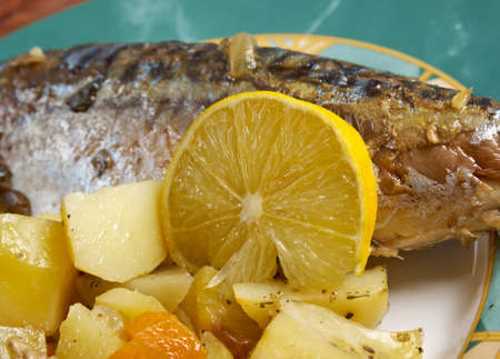 Dish of grilled mackerel and potatoes . closeupの写真素材