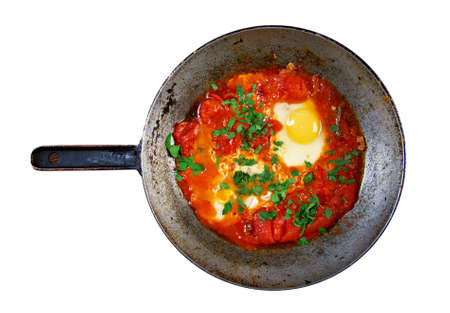 Shakshuka -dish of eggs poached in a sauce of tomatoes, chili peppers, and onions, often spiced with cumin.Moroccan, Tunisian, Libyan, Algerian, and Egyptian cuisines traditionallyの写真素材