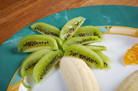 Kids Food.Fruit dessert for child with kiwi, banana and orangeの写真素材