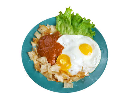 Huevos con chilaquiles -  Mexican traditional breakfast eggs. Eggs with tortilla chips topped with red sauce.の写真素材