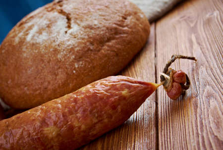 Composition with salami sausages with fresh country  bread .farm-styleの写真素材