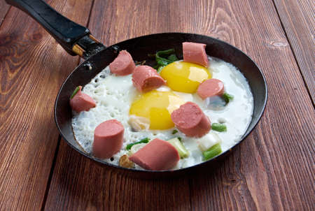 fried eggs with  sausages in a frying pan .breakfast bachelor