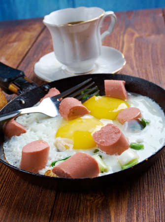 fried eggs with  sausages and a cup of coffee .breakfast bachelorの写真素材