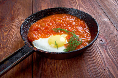 Matbucha and scrambled eggs cooked dish of tomatoes and roasted bell peppers  with garlic and chili pepper. popular across the Maghrebの写真素材