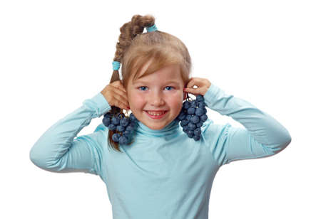 Small girl with grapes, isolated on white background.の写真素材