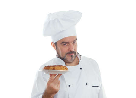 Portrait of chief cook  with cake isolated on whiteの写真素材