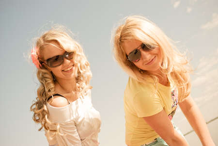 Portrait of two girls on background of summer dayの写真素材
