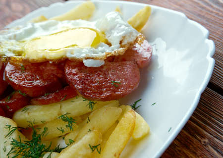 Chorrillana -  Chilean dish consisting of a plate of french fries topped with beef sliced into strips, eggs, fried onions and occasionally sausages.の写真素材