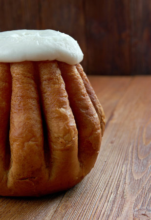 Rum baba  on wooden background. cake saturated in hard liquor, usually rum, and sometimes filled...