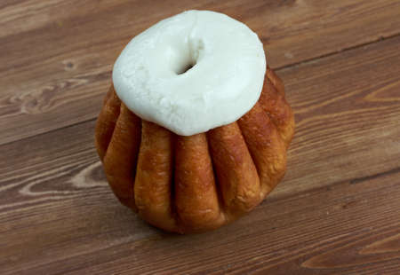 Rum baba  on wooden background. cake saturated in hard liquor, usually rum, and sometimes filled...