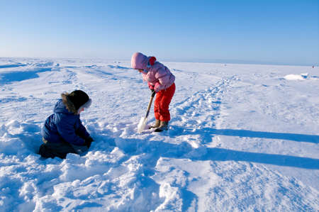 White Sea. Winter Beach.children playing in the snowの写真素材
