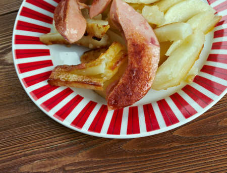 Salchipapas -  fast food dish , street food throughout Latin America.consist of thinly sliced...